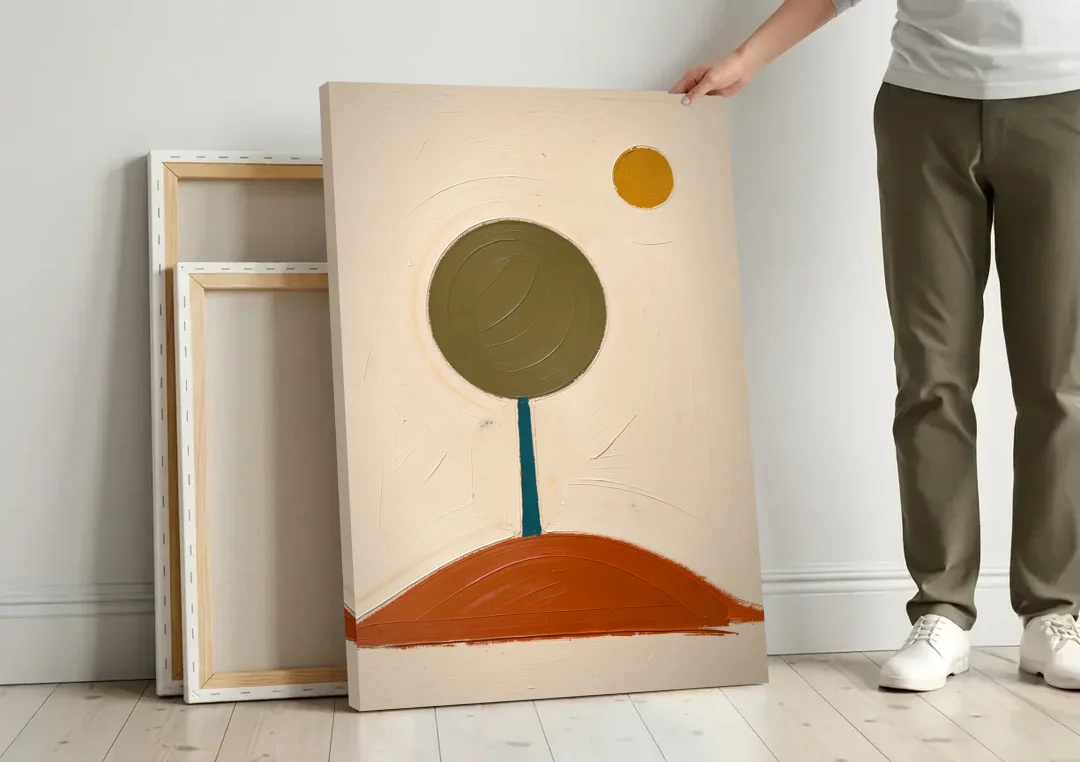 Mid Century Abstract Wall Art with Olive Circle Tree canvas wall art leaning against a wall next to blank canvases