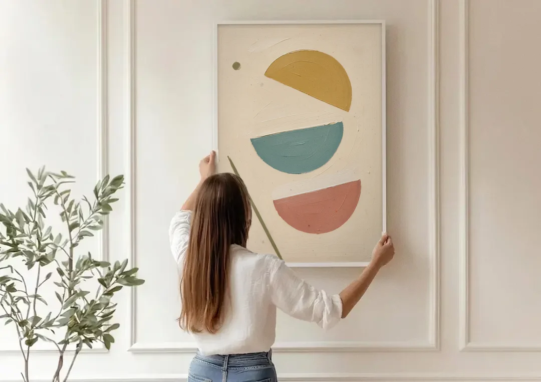 Mid Century Modern Prints of Three Tipping Half Moons canvas wall art being hung on a paneled wall