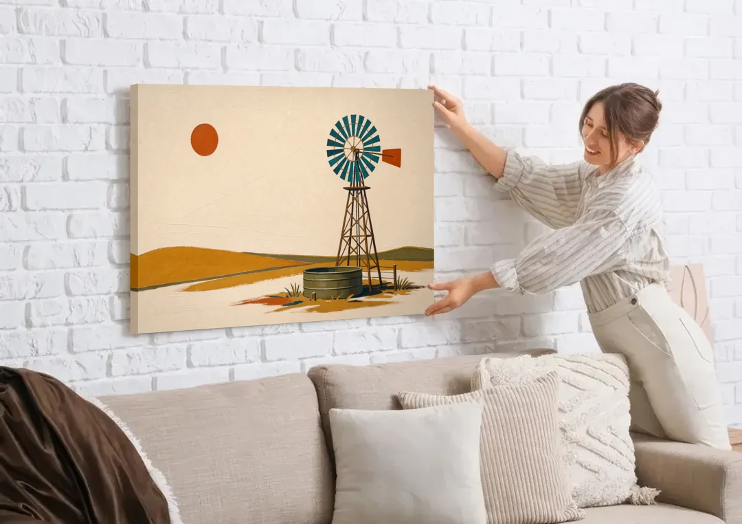 Mid Century Modern Western Art Windmill and Stock Tank canvas wall art being hung on a white brick wall above a sofa
