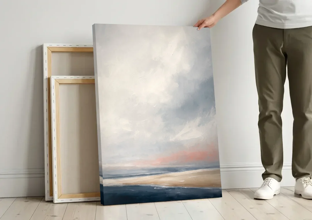 Minimalist Abstract Chalk Sky Over a Sandbar canvas wall art leaning against a wall next to blank canvases