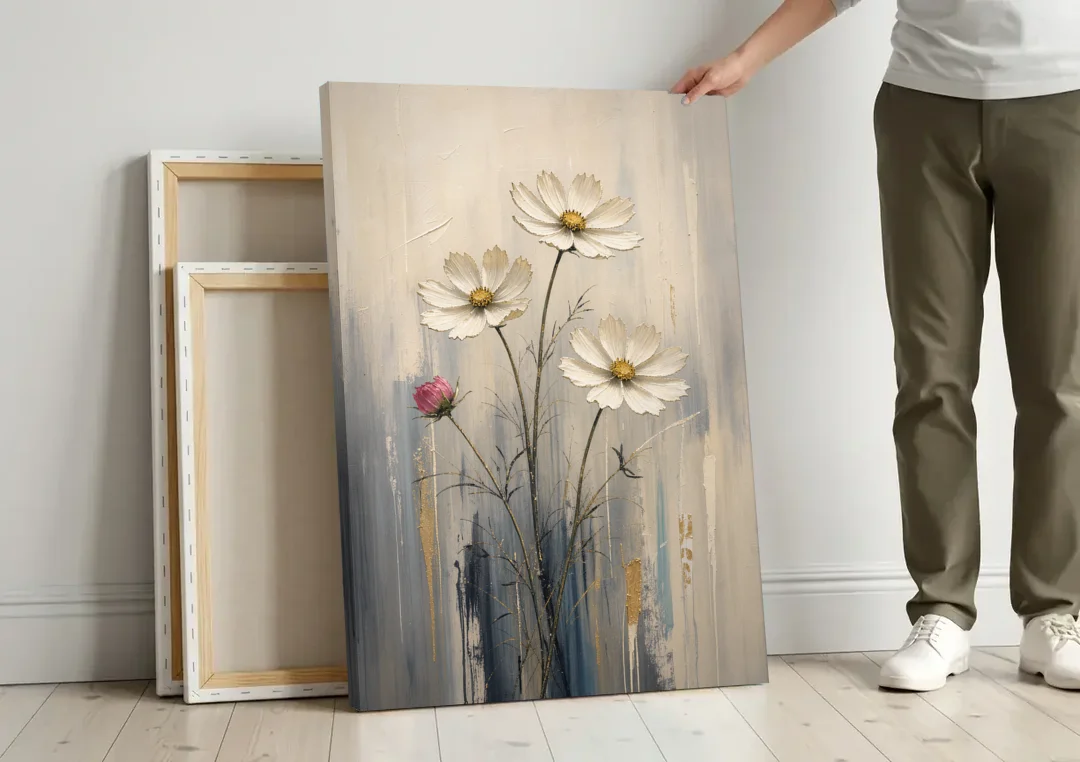 Minimalist Floral Wall Art with White Cosmos canvas wall art leaning against a wall next to blank canvases