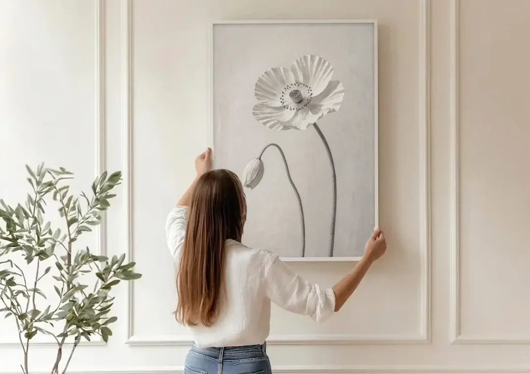 Minimalist Flower Wall Art of a Poppy and Bud canvas wall art being hung on a paneled wall