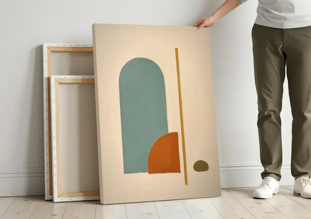 Minimalist Geometric Teal Arch with Terracotta Half-Circle canvas wall art leaning against a wall next to blank canvases