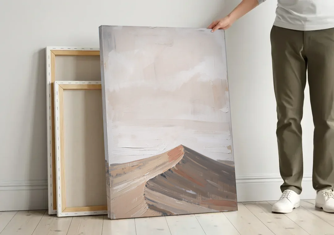 Minimalist Landscape Wall Art of a Sand Dune Ridge canvas wall art leaning against a wall next to blank canvases