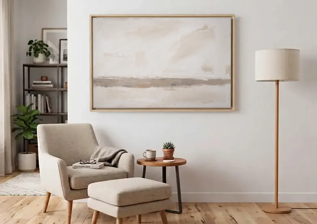 Minimalist Neutral Wall Art with Taupe Dawn Horizon canvas wall art above an armchair in a bright living room