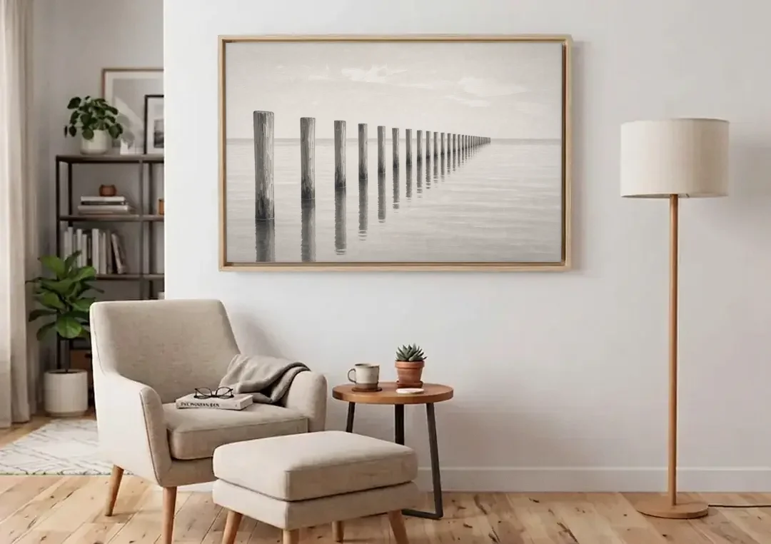 Minimalist Office Wall Art of Old Pier Pilings canvas wall art above an armchair in a bright living room