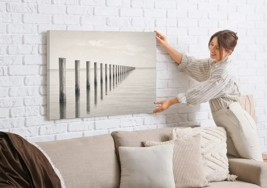 Minimalist Office Wall Art of Old Pier Pilings canvas wall art being hung on a white brick wall above a sofa