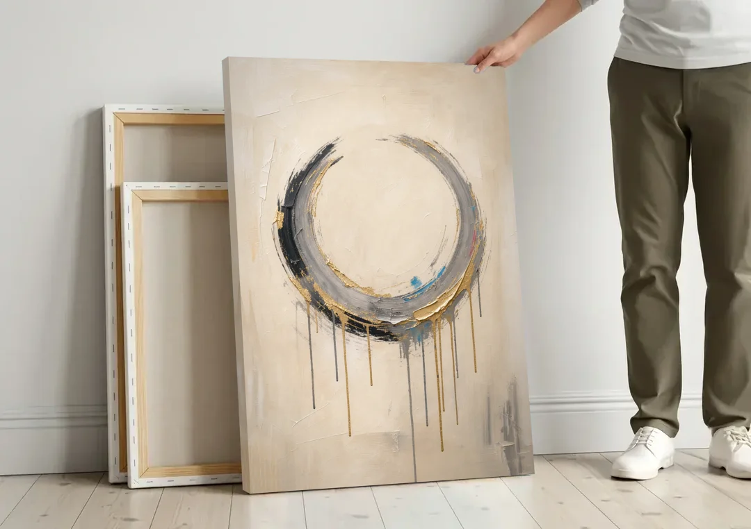 Minimalist Textured Gilded Enso Circle canvas wall art leaning against a wall next to blank canvases