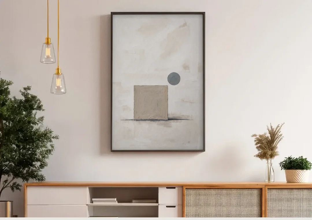 Minimalist Wall Decor with Driftwood Square and Slate Circle canvas wall art above a wooden sideboard under pendant lights