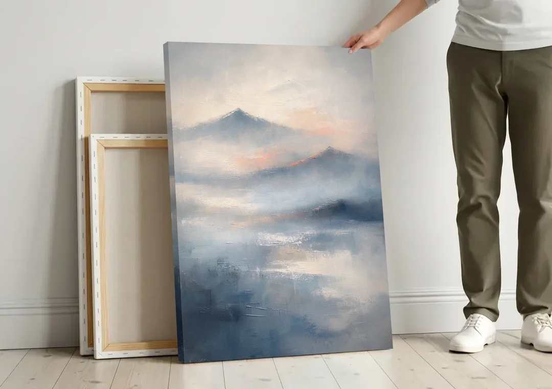 Misty Mountain Painting of Fading Summits canvas wall art leaning against a wall next to blank canvases