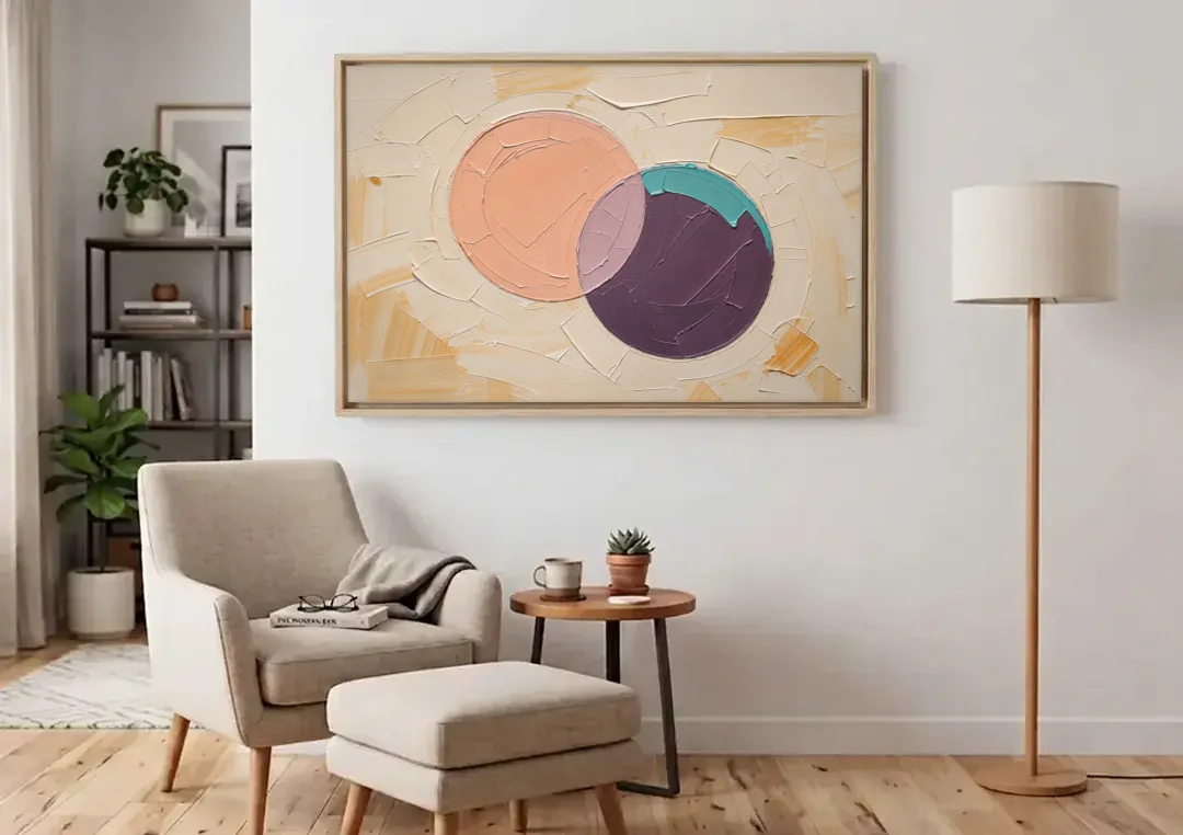 Modern Abstract Overlapping Peach and Plum Discs canvas wall art above an armchair in a bright living room