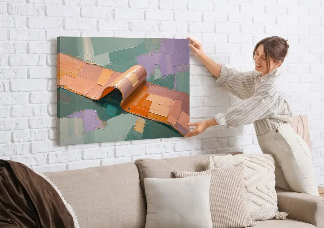 Modern Abstract Painting with Rolling Peach Ribbon canvas wall art being hung on a white brick wall above a sofa