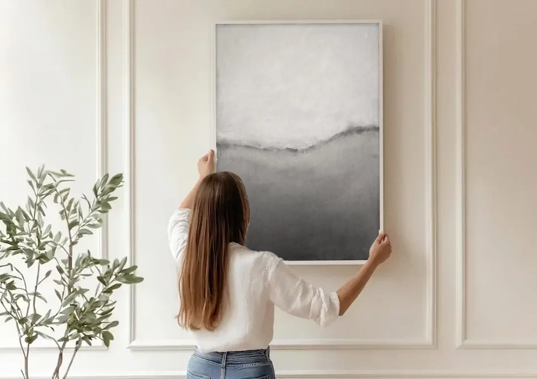 Modern Black and White Abstract Feathered Grey Seam canvas wall art being hung on a paneled wall