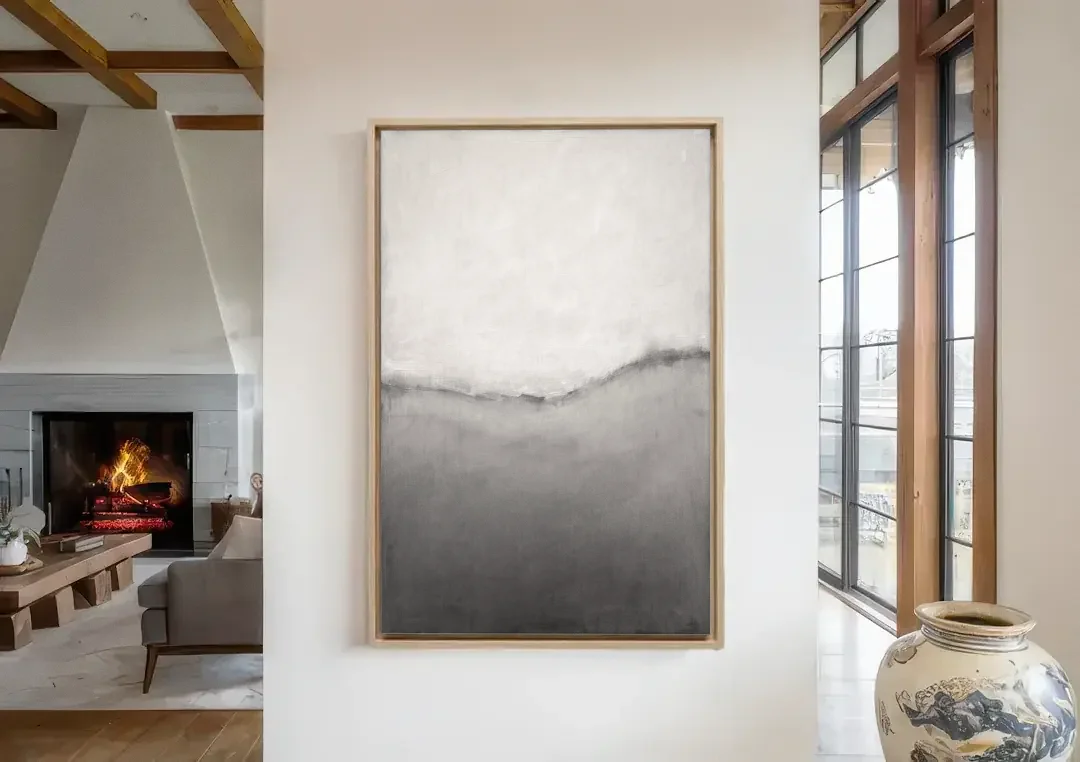 Modern Black and White Abstract Feathered Grey Seam canvas wall art in a living room with a fireplace