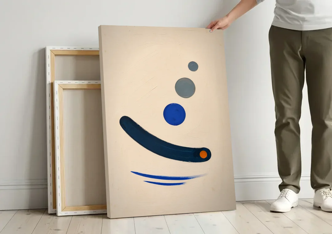 Modern Blue Wall Art with a Navy Boomerang canvas wall art leaning against a wall next to blank canvases