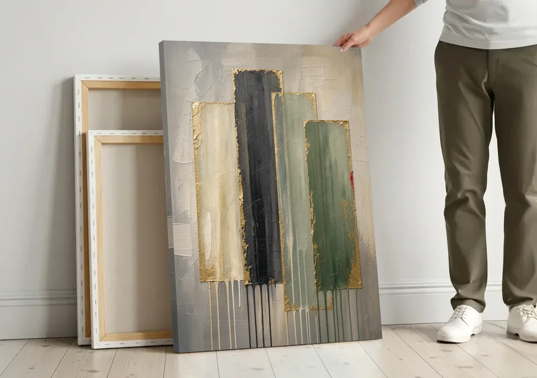 Modern Green and Gold Abstract Dripping Veils canvas wall art leaning against a wall next to blank canvases