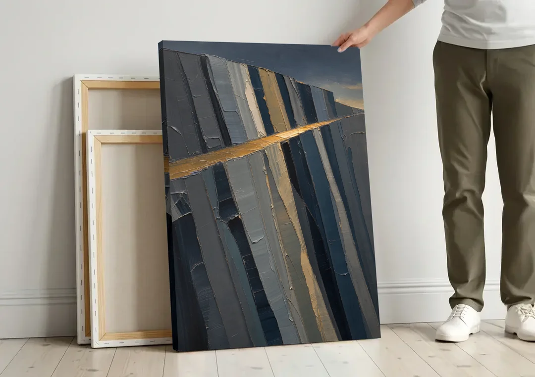 Modern Masculine Charcoal Gray Cliff with Ochre Ledge canvas wall art leaning against a wall next to blank canvases