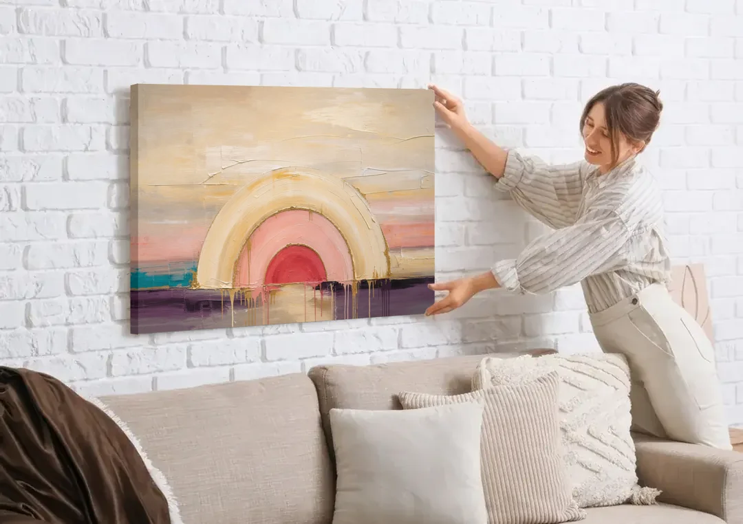 Modern Neutral Nested Blush Arches canvas wall art being hung on a white brick wall above a sofa