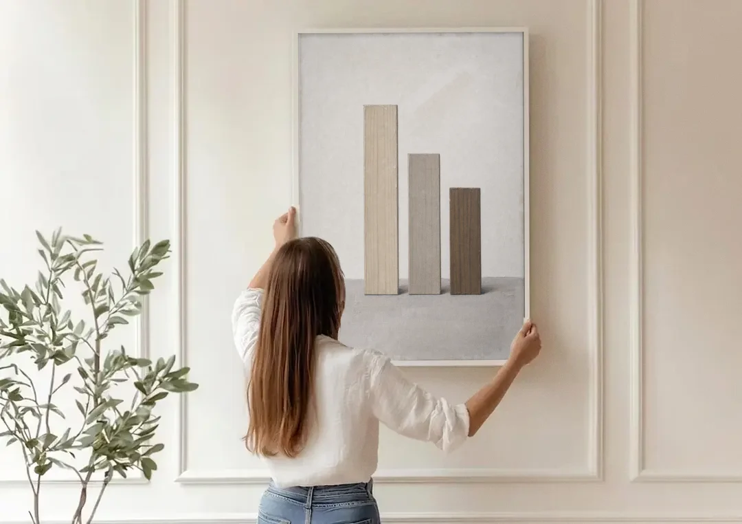 Modern Scandinavian Wall Art of Three Wooden Slats canvas wall art being hung on a paneled wall