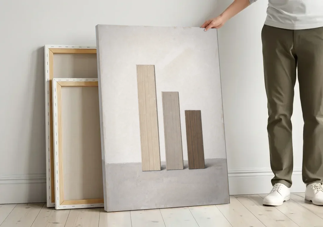 Modern Scandinavian Wall Art of Three Wooden Slats canvas wall art leaning against a wall next to blank canvases