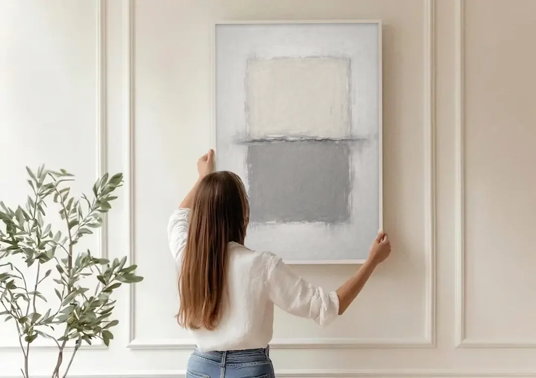 Monochrome Abstract Wall Art with a Charcoal Seam canvas wall art being hung on a paneled wall