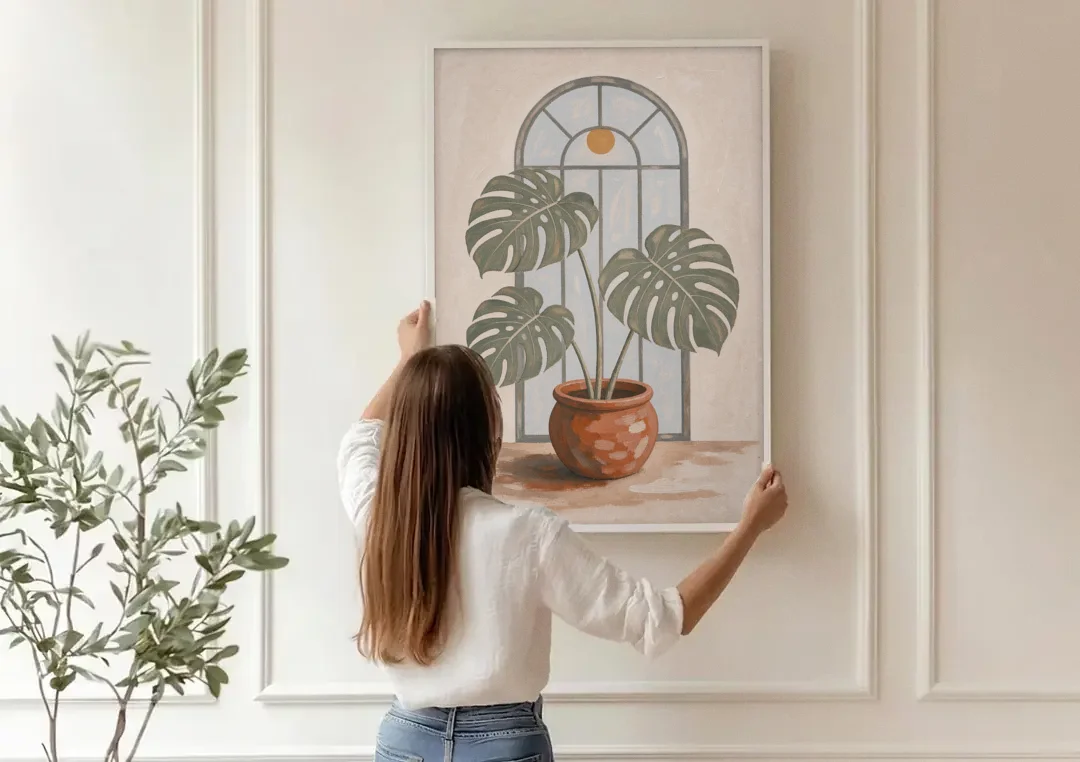 Monstera Wall Art Under the Arched Window canvas wall art being hung on a paneled wall