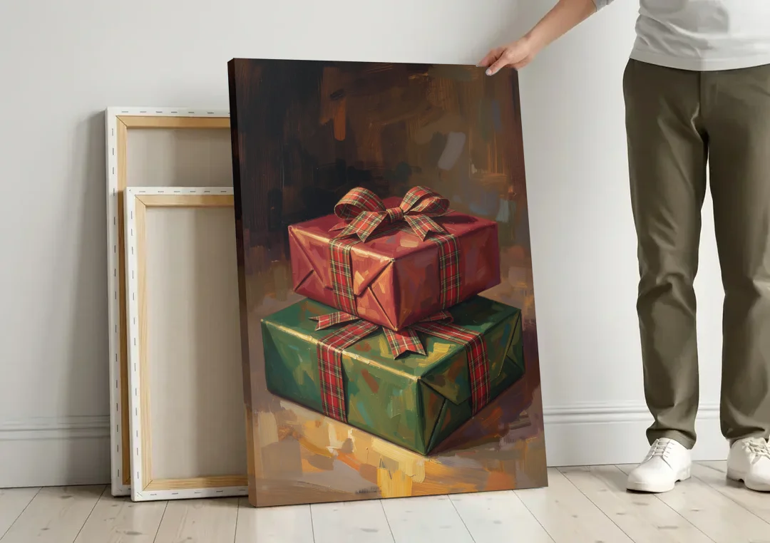 Moody Christmas Wall Art of Two Stacked Plaid Gifts canvas wall art leaning against a wall next to blank canvases