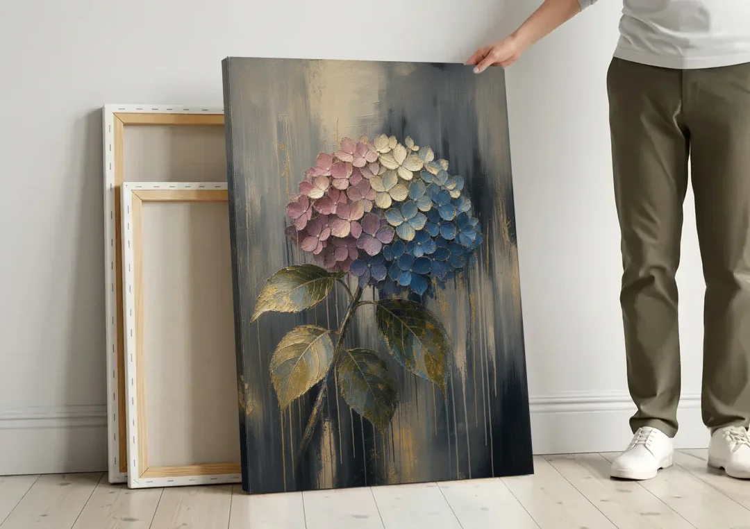 Moody Floral Wall Art of a Drooping Hydrangea canvas wall art leaning against a wall next to blank canvases