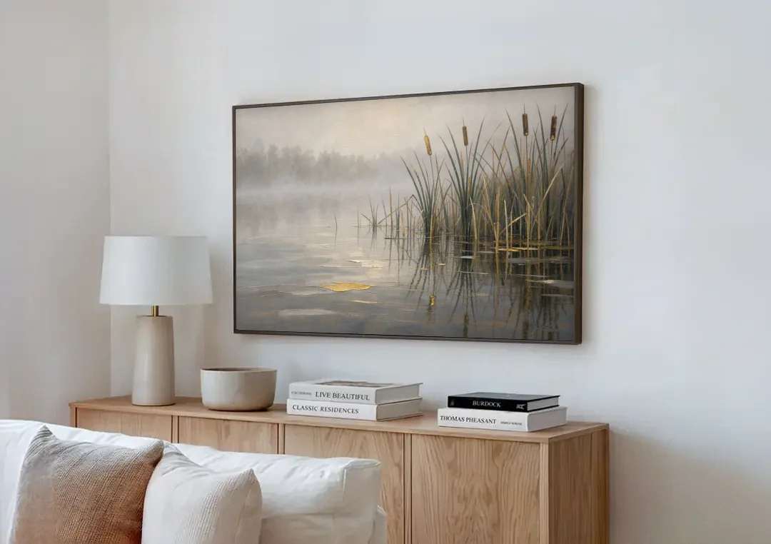 Moody Landscape Wall Art with Cattails in Fog canvas wall art above a wooden sideboard next to a sofa