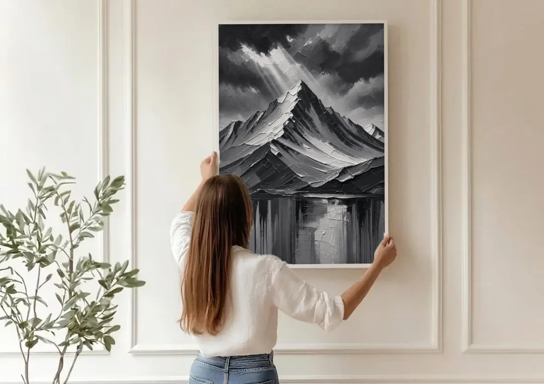 Moody Mountain Painting Under Breaking Light canvas wall art being hung on a paneled wall