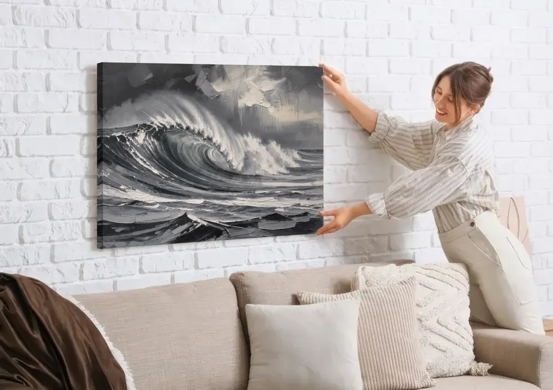 Moody Wall Art of a Breaking Storm Wave canvas wall art being hung on a white brick wall above a sofa