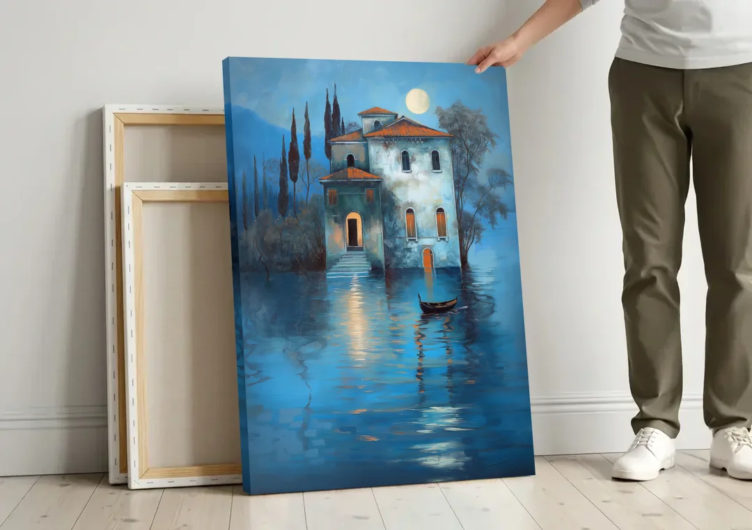 Moonlight Painting of a Lakeside Villa canvas wall art leaning against a wall next to blank canvases