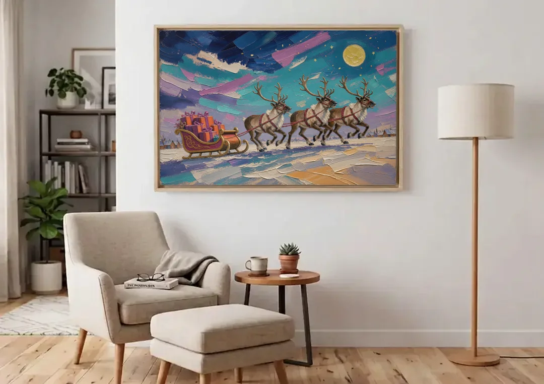 Large Christmas Moonlit Reindeer Sleigh Run canvas wall art above an armchair in a bright living room