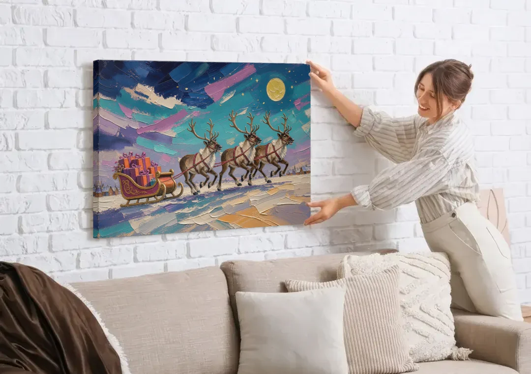 Large Christmas Moonlit Reindeer Sleigh Run canvas wall art being hung on a white brick wall above a sofa