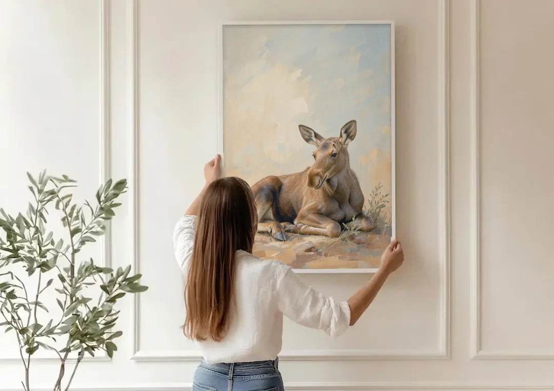 Moose Calf at Rest for the Modern Nursery canvas wall art being hung on a paneled wall