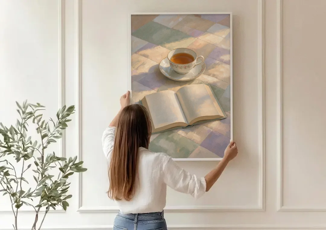 Morning Light Painting of Tea and an Open Book canvas wall art being hung on a paneled wall
