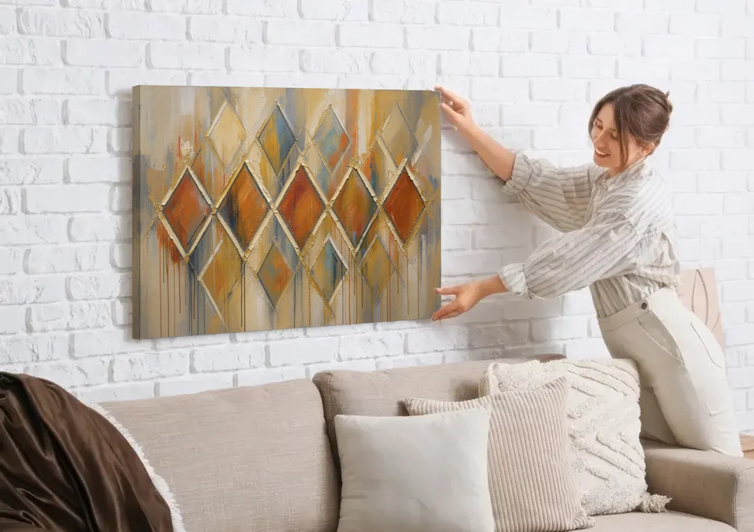 Moroccan Wall Art Diamond Lattice in Rust and Gold canvas wall art being hung on a white brick wall above a sofa