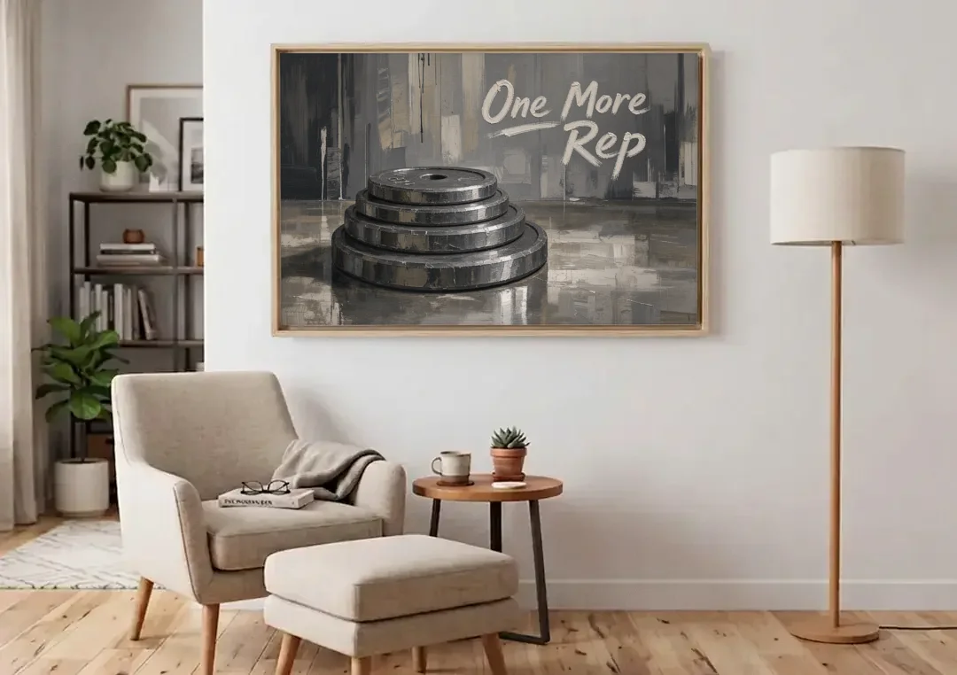 Motivational Quote Canvas One More Rep Weight Stack canvas wall art above an armchair in a bright living room