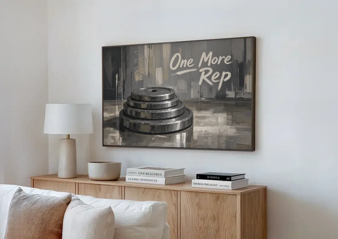 Motivational Quote Canvas One More Rep Weight Stack canvas wall art above a wooden sideboard next to a sofa