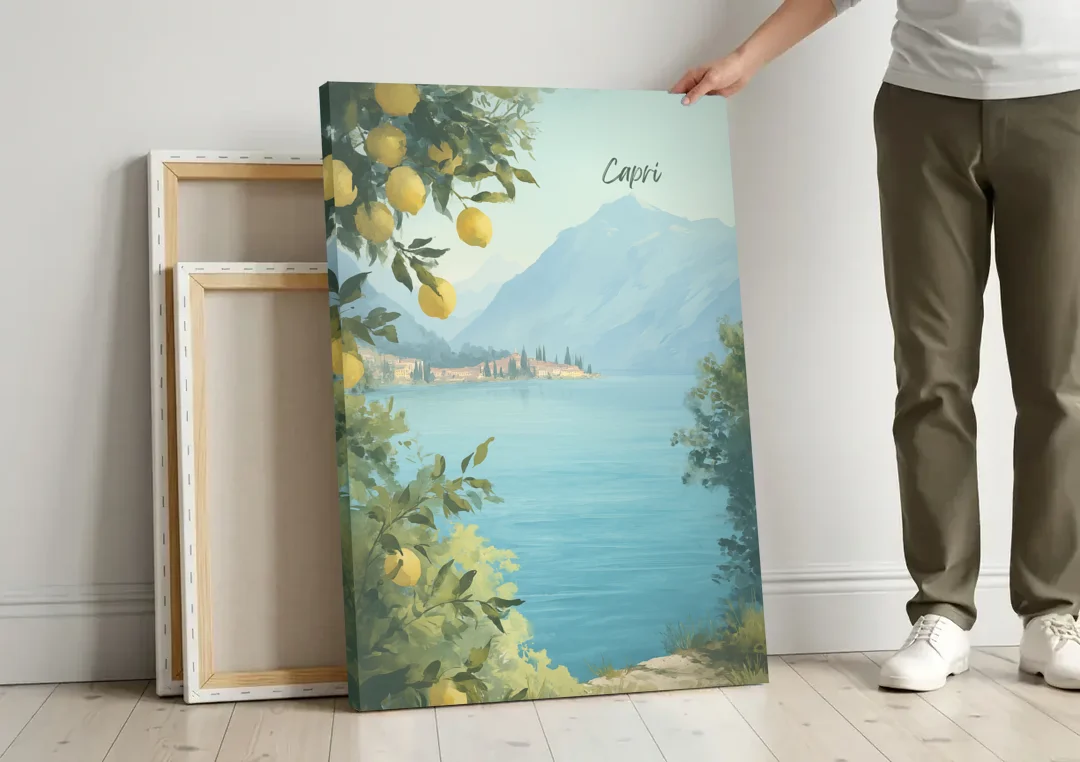 Mountain Lake Painting with Lemon Branches canvas wall art leaning against a wall next to blank canvases