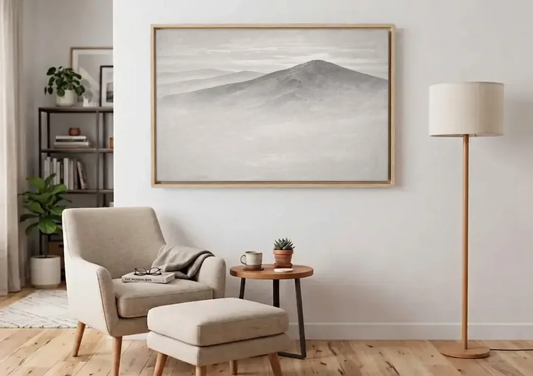 Mountain Ridge Above a Sea of Mist canvas wall art above an armchair in a bright living room