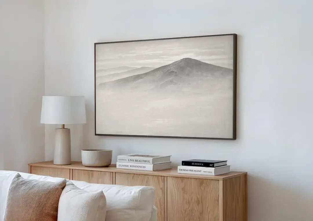 Mountain Ridge Above a Sea of Mist canvas wall art above a wooden sideboard next to a sofa