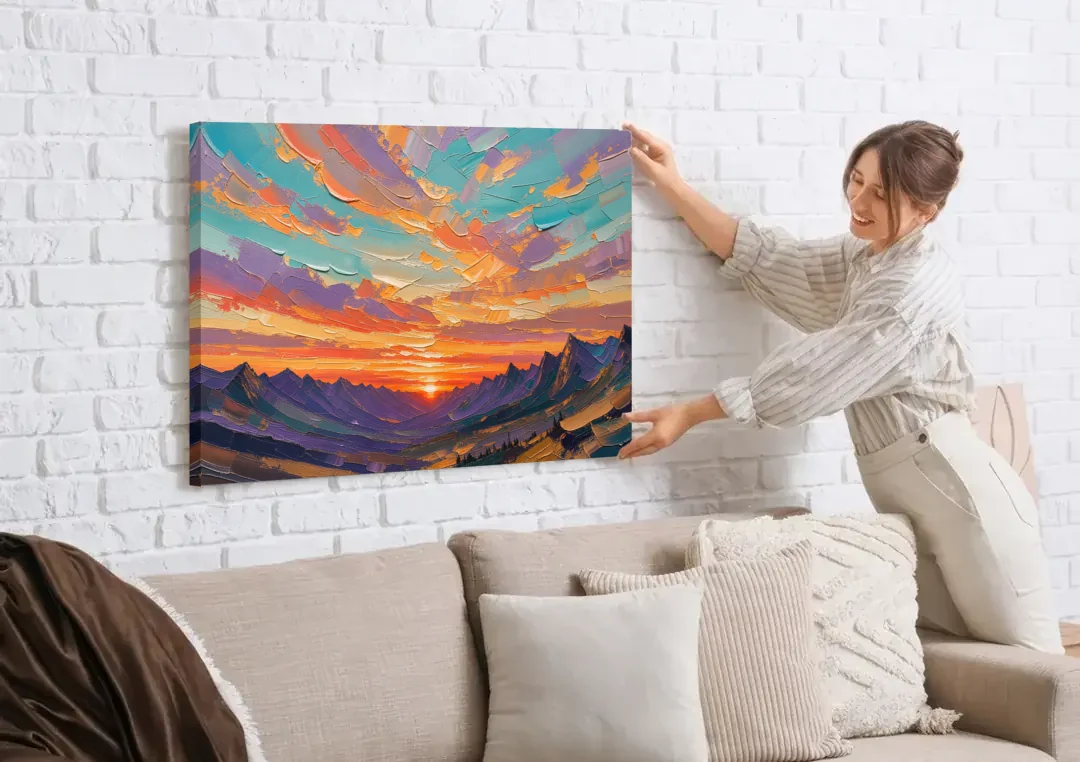 Mountain Sunset Painting Over a Violet Valley canvas wall art being hung on a white brick wall above a sofa
