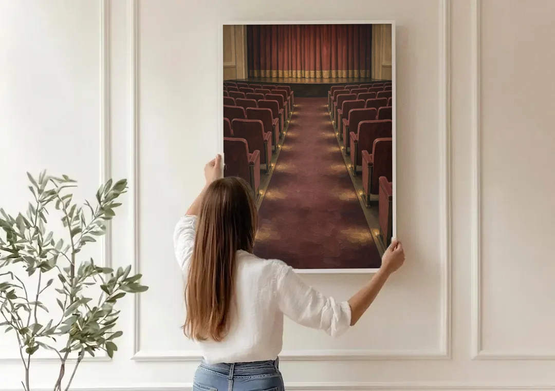 Movie Theater Painting of the Lit Aisle canvas wall art being hung on a paneled wall