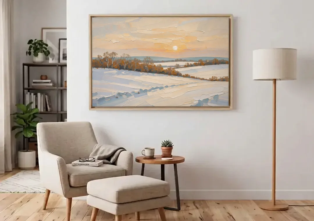 Muted Pale Sun Over Snowy Fields canvas wall art above an armchair in a bright living room