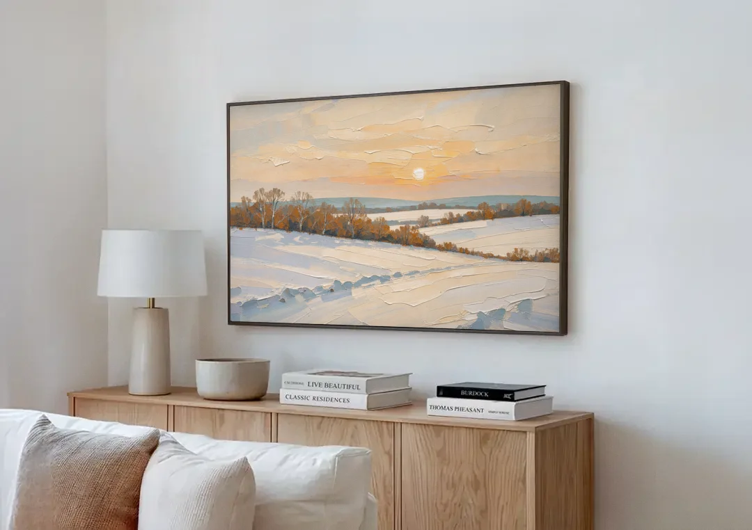 Muted Pale Sun Over Snowy Fields canvas wall art above a wooden sideboard next to a sofa