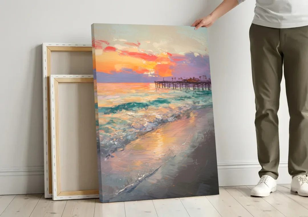 Naples Beach Sunset canvas wall art leaning against a wall next to blank canvases