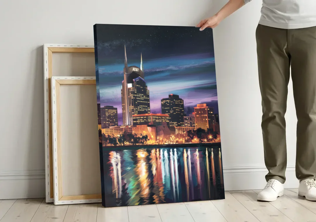 Nashville Cityscape at Night canvas wall art leaning against a wall next to blank canvases