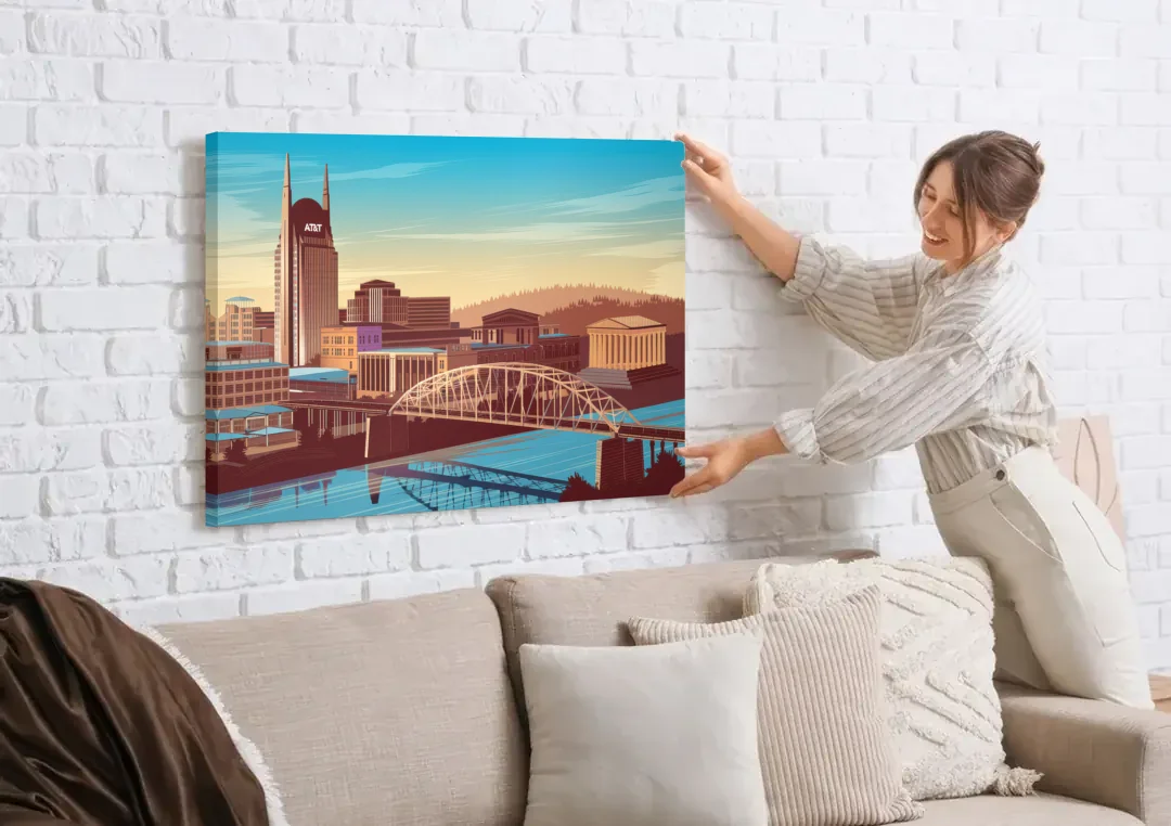 Nashville Historic Landmarks canvas wall art being hung on a white brick wall above a sofa