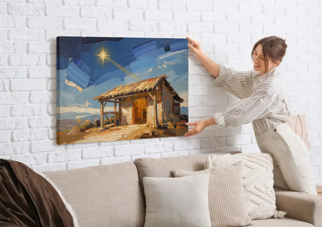 Nativity Scene Painting with Golden Doorway canvas wall art being hung on a white brick wall above a sofa